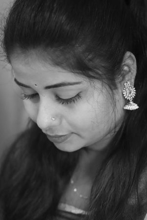 pexels-photo-12431105-12431105 A serene portrait of an Indian woman wearing traditional earrings in grayscale.